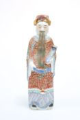 A CHINESE PORCELAIN FIGURE OF AN IMMORTAL