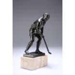 A PATINATED METAL FIGURE OF A HOCKEY PLAYER