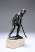 A PATINATED METAL FIGURE OF A HOCKEY PLAYER