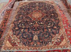 A SAROG CARPET, the central medallion with outer red border, on a blue ground