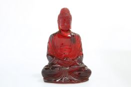 A CHINESE MODEL OF A SEATED BUDDHA, POSSIBLY CHERRY AMBER