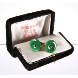 A PAIR OF CHINESE JADE AND DIAMOND CUFFLINKS, the round jade disc centred by a four-claw set