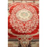 A LARGE CHINESE CARPET, with a red ground. 386cm by 266cm