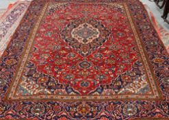 A KASHAN CARPET, with a central medallion within a blue ground medallion