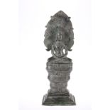 A CAMBODIAN BRONZE BUDDHA, seated with Naga, 18th Century. 33.5cm