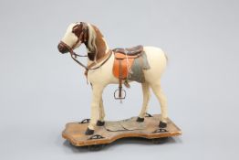 A 19TH CENTURY PUSH-ALONG HORSE