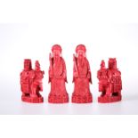 FOUR 19TH CENTURY CHINESE RED STAINED IVORY CHESS PIECES