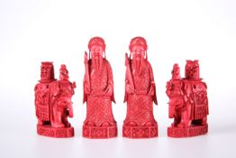 FOUR 19TH CENTURY CHINESE RED STAINED IVORY CHESS PIECES