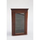 A SMALL GLAZED MAHOGANY CORNER CUPBOARD