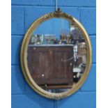 A VICTORIAN GILT-COMPOSITION OVAL MIRROR