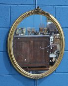 A VICTORIAN GILT-COMPOSITION OVAL MIRROR