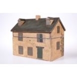 A PRIMITIVE PAINTED WOODEN BOX IN THE FORM OF A HOUSE