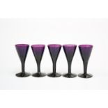 A SET OF FIVE AMETHYST GLASS PORT OR SHERRY GLASSES, SECOND QUARTER 19th CENTURY