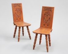 A PAIR OF VICTORIAN CARVED OAK HALL CHAIRS