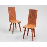 A PAIR OF VICTORIAN CARVED OAK HALL CHAIRS