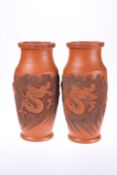 A PAIR OF JAPANESE TERRACOTTA VASES DECORATED WITH DRAGONS