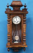 A 19TH CENTURY WALNUT VIENNA PATTERN WALL CLOCK