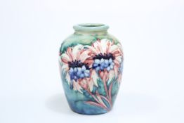 A WALTER MOORCROFT POTTERY CORNFLOWER PATTERN VASE