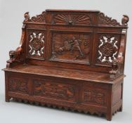 A LATE 19TH CENTURY CARVED OAK SETTLE