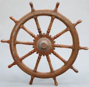 A LARGE HARDWOOD SHIP'S WHEEL OF OVER 5-FOOT DIAMETER