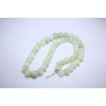 A STRING OF JADE BEADS