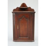 A GEORGE III OAK CORNER CUPBOARD