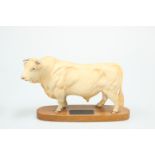 A BESWICK MODEL OF A CHAROLAIS BULL, on wooden plinth. 20cm high