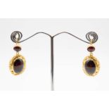 A PAIR OF GARNET SET EARRINGS