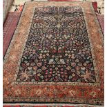 A TABRIZ CARPET, the blue-ground centre decorated with dense flowering foliage