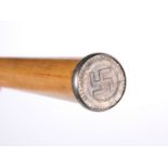 A MALACCA CANE, topped with a white-metal roundel with Swastika and date 1941