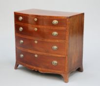 AN EARLY 19TH CENTURY MAHOGANY BOW-FRONT CHEST OF DRAWERS