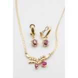 A RUBY AND DIAMOND PENDANT AND EARRING SET