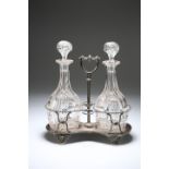A PAIR OF EDWARDIAN CUT-GLASS DECANTERS IN A SILVER-PLATED STAND