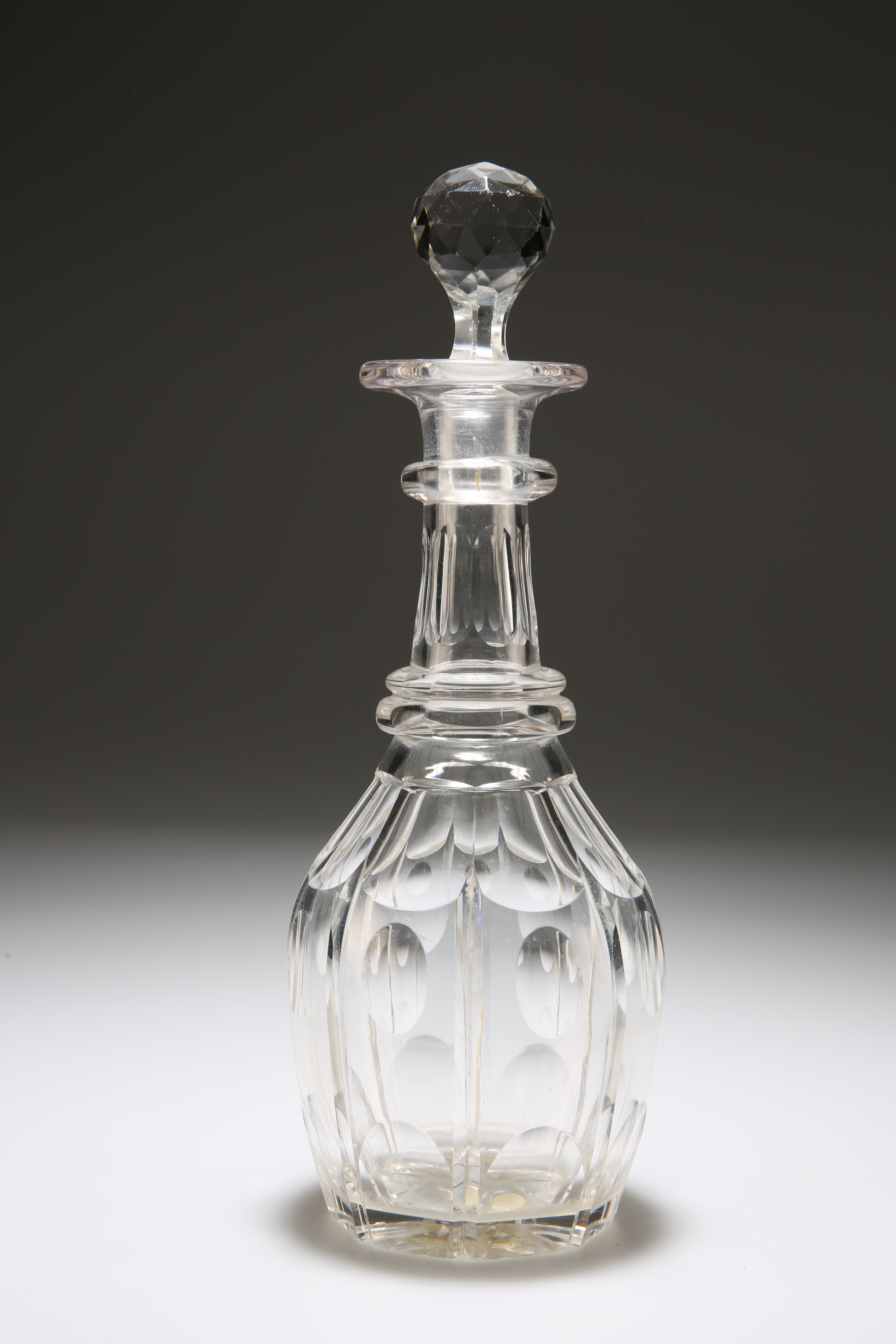 A CUT-GLASS BARREL-SHAPED DECANTER