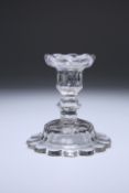 A GEORGE III CUT-GLASS CANDLESTICK, the domed base with petal edge