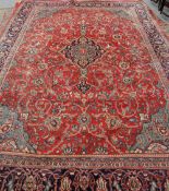 A LARGE MAHAL CARPET, with a central blue medallion against a red ground