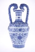 A CHINESE BLUE AND WHITE PORCELAIN TWO-HANDLED AMPHORA