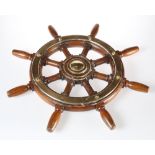 A BRASS-MOUNTED TEAK SHIPS WHEEL, of eight-spoke design. 60.5cm