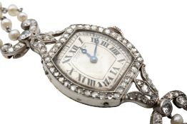 AN EARLY 20TH CENTURY SEED PEARL AND DIAMOND BRACELET WATCH, BY CARTIER