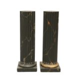 A PAIR OF FAUX MARBLE COMPOSITION COLUMNS