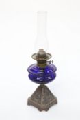 A QUEEN VICTORIA BLUE GLASS AND CAST IRON OIL LAMP