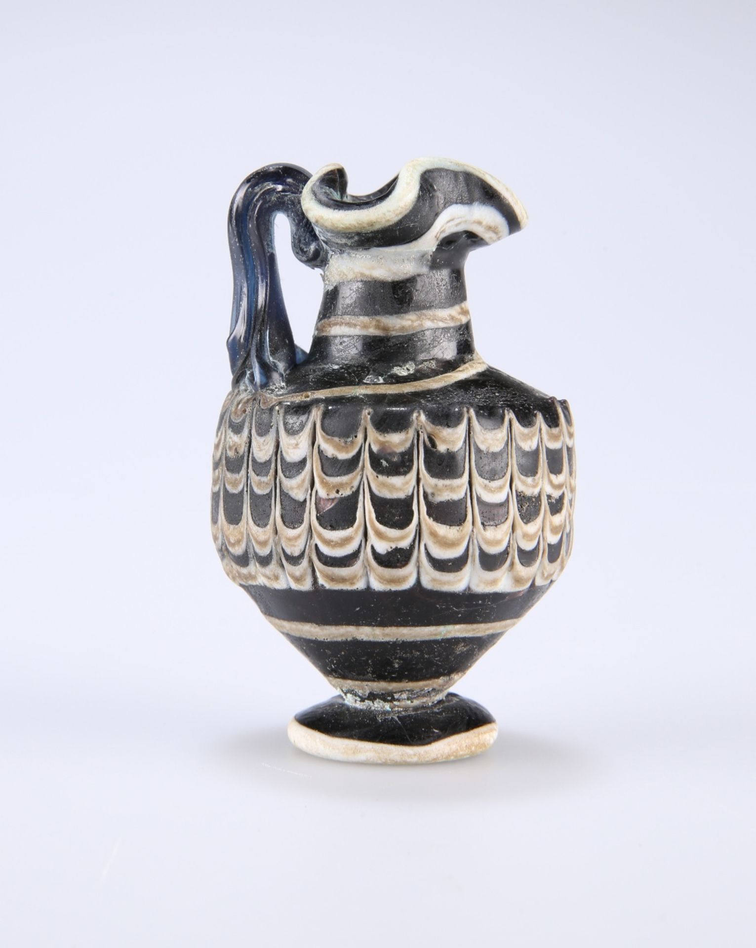 A RARE GREEK CORE-FORMED GLASS OINOCHOE, CIRCA 1ST-4TH CENTURY BC