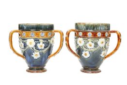 A NEAR PAIR OF ROYAL DOULTON STONEWARE TYGS