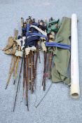 A COLLECTION OF OLD FISHING RODS AND OTHER TACKLE ITEMS