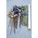 A COLLECTION OF OLD FISHING RODS AND OTHER TACKLE ITEMS