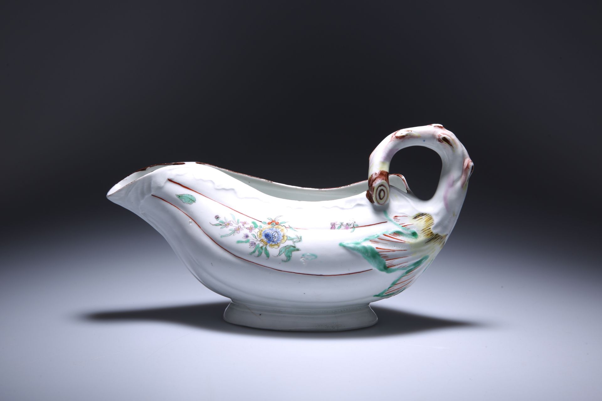 A RARE WORCESTER PORCELAIN POLYCHROME LEAF SAUCE BOAT WITH CONJOINED LIP, c. 1760