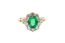 AN EMERALD AND DIAMOND CLUSTER RING