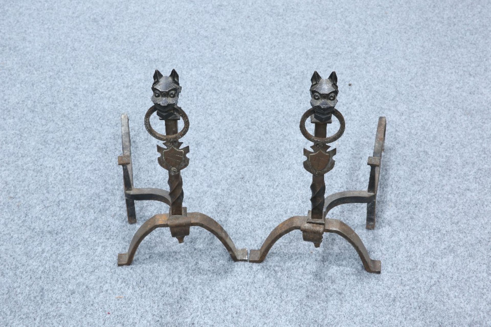 A PAIR OF WROUGHT IRON FIRE DOGS