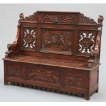 A LATE 19TH CENTURY CARVED OAK SETTLE