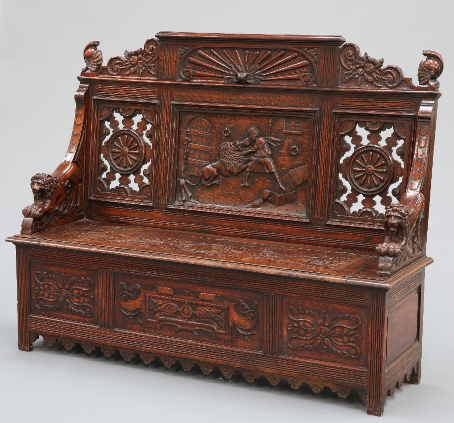 A LATE 19TH CENTURY CARVED OAK SETTLE